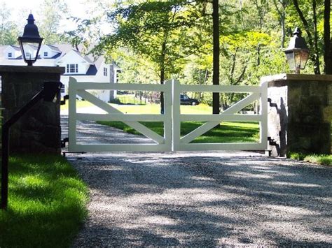 This simple garden fence with wire and logs adds rustic charm while it works to keep the plants safe. Image result for aluminum split rail driveway gate | Front ...