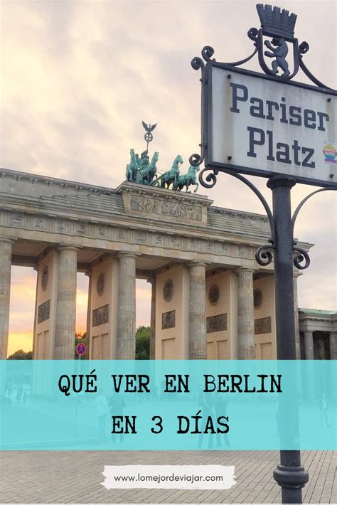 A Street Sign In Front Of A Building With Columns And Statues On The