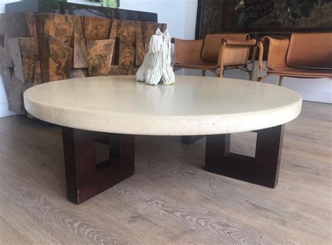 First, to assemble, the table legs clip into the center hole of the glass tabletop. Round Coffee Table with Cork Top by Paul Frankl at 1stdibs