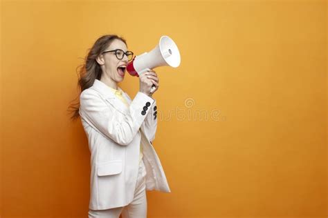 Business Girl In Glasses And Suit Announces Information Into Megaphone