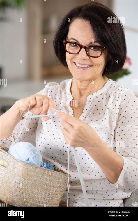 Cheerful Senior Woman Is Knitting Stock Photo Alamy