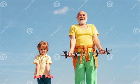 Portrait Of A Healthy Father And Son Working Out With Dumbbells Over