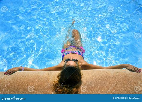 Attractive Woman In Bikini And Sunglasses Sunbathing Leaning On Edge Of