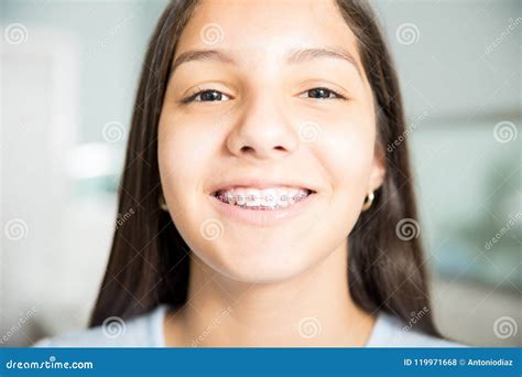 Smiling Teenage Girl Wearing Braces At Dental Clinic Stock Photo