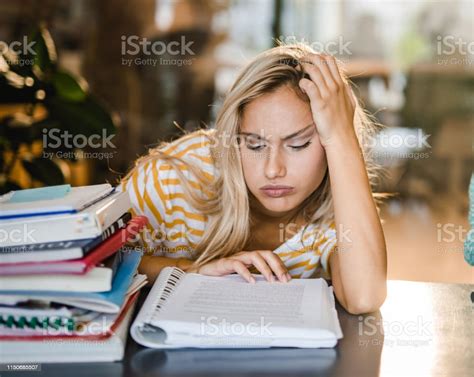 Bored Female College Student Learning A Lecture In The Library Stock