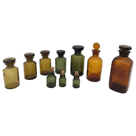 Set Of 10 French Perfume Pharmacy Bottles In Green And Amber With Lids Stopper For Sale At 1stdibs