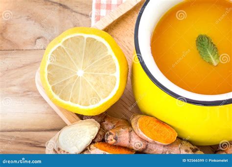 A Cup Of Turmeric Tea With Lemon And Ginger Benefits For Reduce