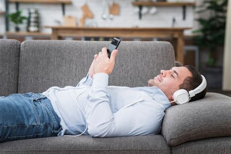 Free Photo Front View Of Man Lying Down On Couch