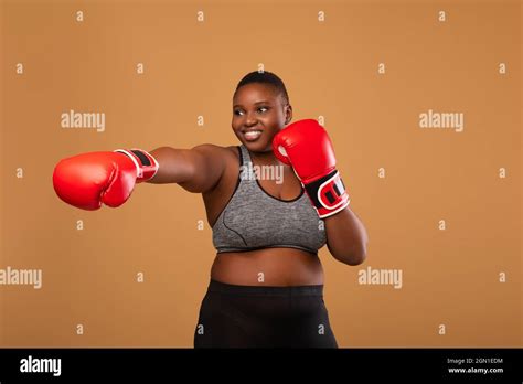 Young Black Woman Boxing Wearing Red Gloves Throwing Punch Stock Photo