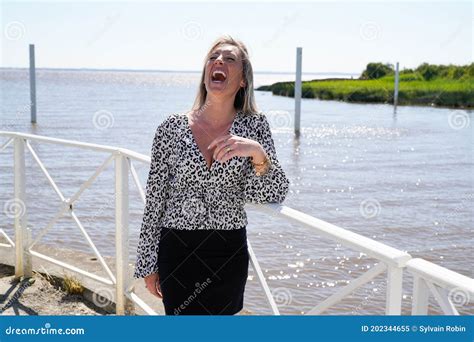 portrait of happy beautiful blonde woman enjoy smiling laughing on summer vacation stock image