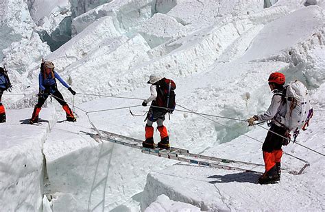 Climbers Crossing A Crevasse On Everest Photograph By Jake Norton