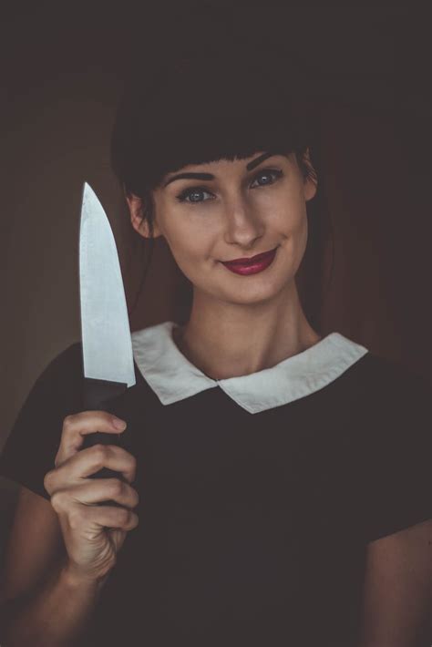 Smiling Woman Holding Knife · Free Stock Photo