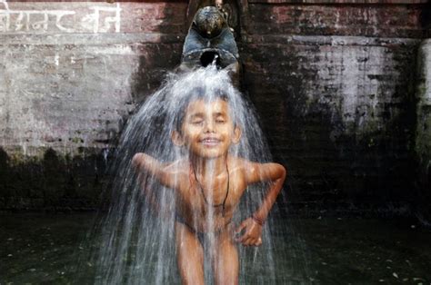 A Boy Bathes In Water From A Stone Spout Near Bangalamukhi Temple In Katmandu Nepal Tuesday