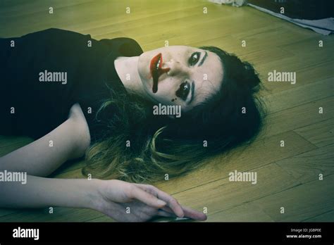 Dead Girl On The Floor With Blood From Her Mouth And Nose Stock Photo