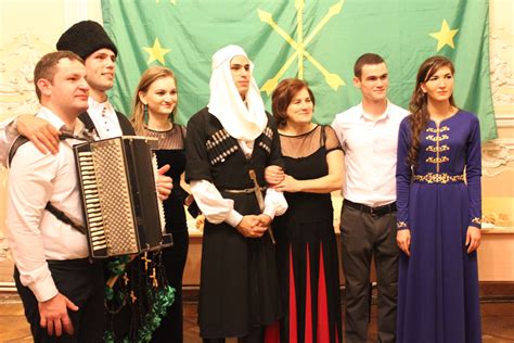 Group Of Circassians In Front Of The Green And Gold Flag Of Circassia
