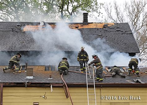 Firefighters Ventilating A Roof