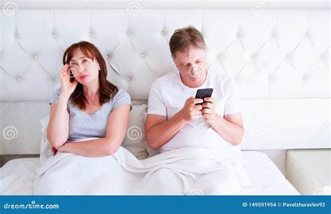 Relationship Problems Concept A Middle Aged Couple Lying In Bed In