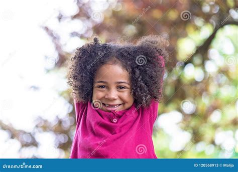 Portrait Of A Beautiful Pre School Girl With Lovely Curly Hair Stock