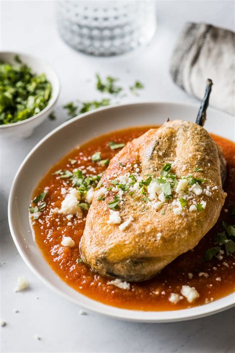 an authentic chile relleno recipe made from roasted poblano peppers stuffed with… chile