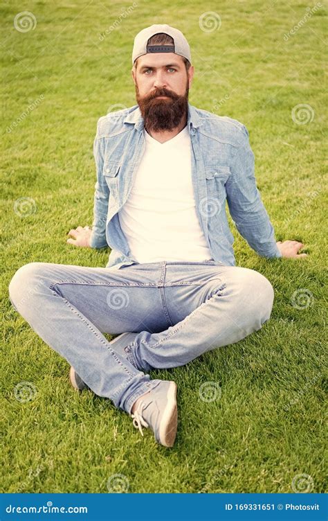 Hairy Hipster Brutal Hipster Sitting On Green Grass Bearded Man In Trendy Hipster Style On