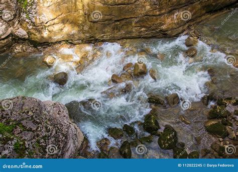 Mountain River Flowing Through The Green Forest And Many Stones Stock