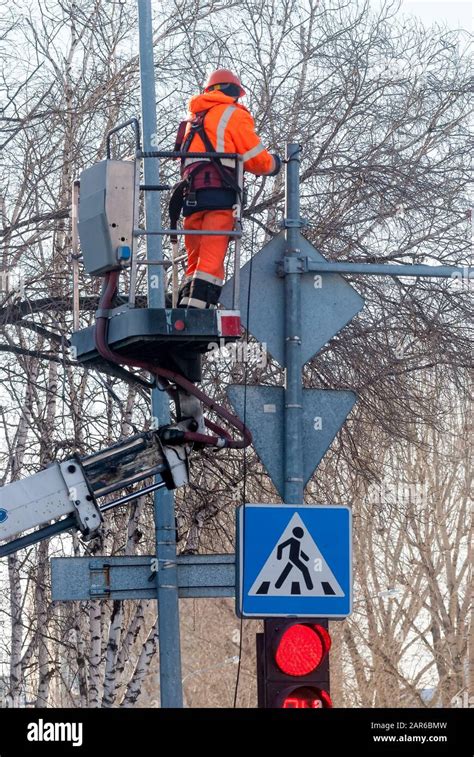 Workers Mount A Traffic Light And Road Signs Stock Photo Alamy