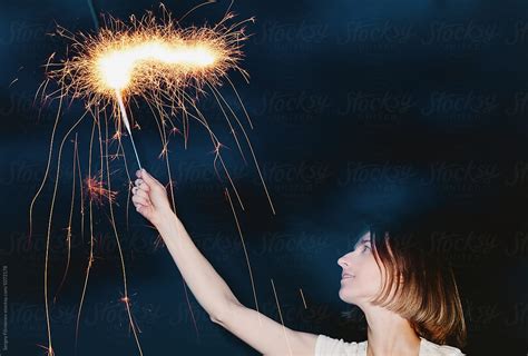 Woman Posing With Burning Sparkler In Night Del Colaborador De Stocksy Sergey Filimonov