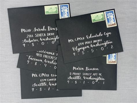 White Ink Calligraphy On Black Envelopes Are A Striking Way To Make
