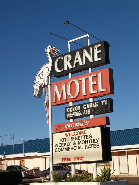 A Crane Motel Sign In Front Of A Building