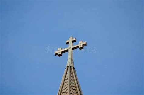 Cross Standing On A Church Roof Against The Blue Sky Stock Image