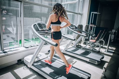 attractive muscular smiling fitness woman running on treadmill in gym stock image image of