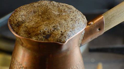 Turkish Coffee Being Prepared Over A Stove Top Reaching A Boiling