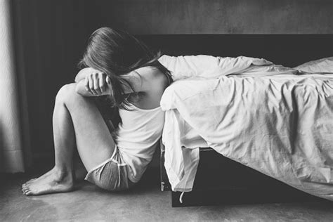 Portrait Of Depressed Woman Sitting Alone On The Floor In The Bedroom