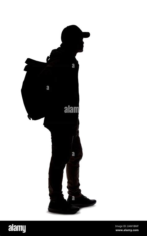 Silhouette Of A Man Hiking And Carrying A Backpack On A White