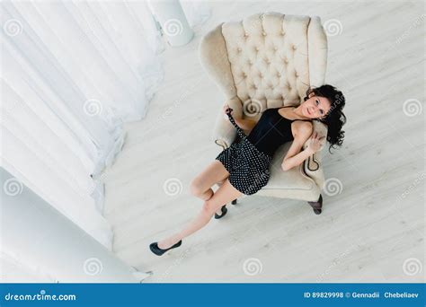 Slender Brunette Lying On A White Armchair Stock Photo Image Of High