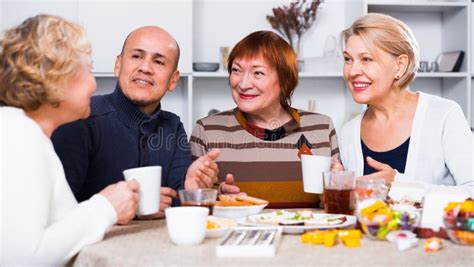 Mature Women And Their Friend Are Drinking Tea And Talking Stock Image