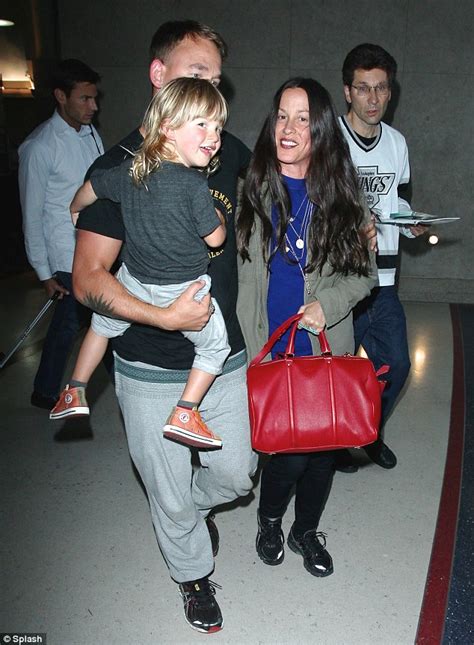 Alanis Morissette And Husband Mario Treadway Walk Hand In Hand As They Return To Los Angeles