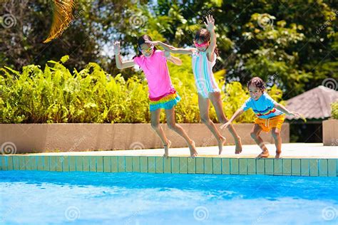 Kids Jump Into Swimming Pool Summer Water Fun Stock Photo Image Of