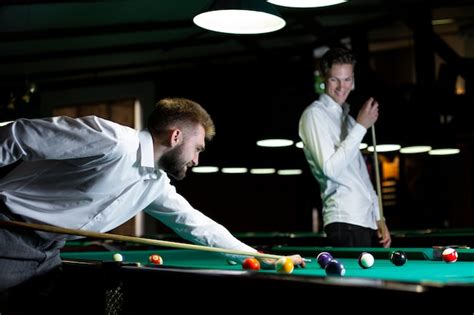 Free Photo Medium Shot Guy With Pool Cue Looking At Table
