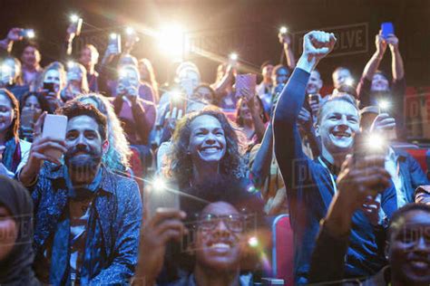 Excited Audience With Smart Phone Flashlights Cheering Stock Photo