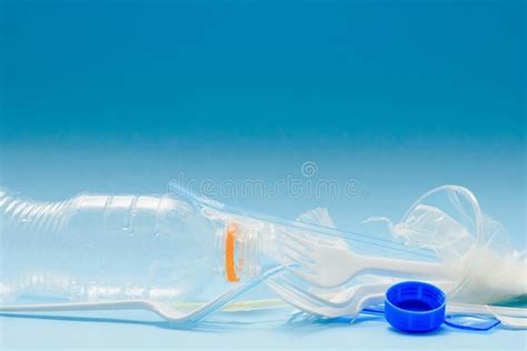 White Single Use Plastic And Other Plastic Items On A Blue Background
