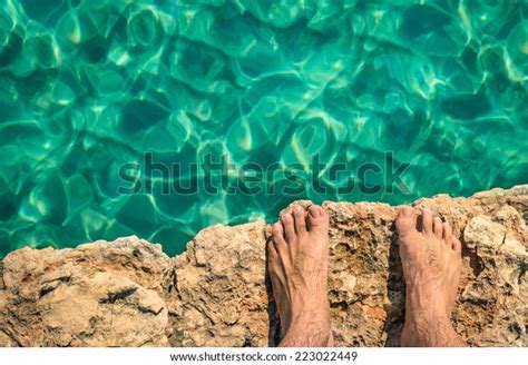 Naked Human Barefeet On Rock Cliff Ready To Jump In The Clear Blue Water Comino And Gozo Blue