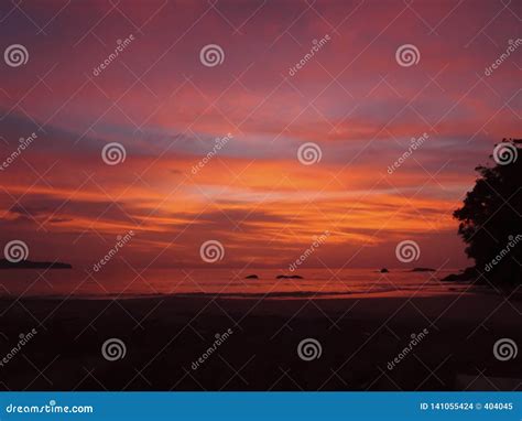 Bright Orange Pink Purple Sunset Colors Over The Calm Sea Stock Photo