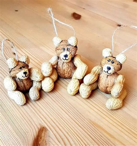 Three Teddy Bears Are Hanging From Twine Strings On A Wooden Table With
