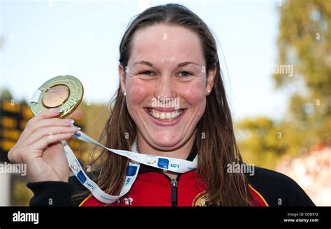 german swimmer jenny mensing poses with her medal in her hand and smiles after taking third