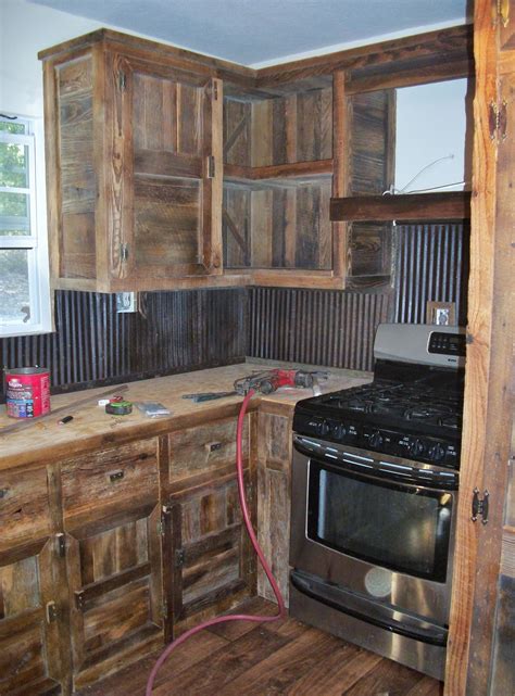 I chose barn wood for several reasons. We built these barn wood cabinets and used old tin for a ...