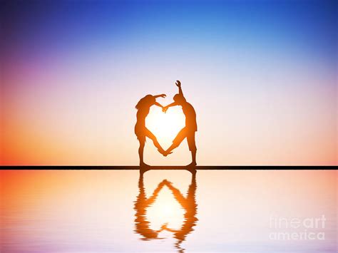 A Happy Couple In Love Making A Heart Shape With Their Bodies At Sunset