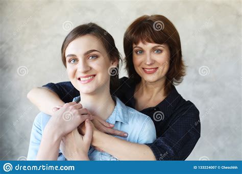 Happy Senior Mother Embracing Adult Daughter Laughing Together Stock Image Image Of Gray