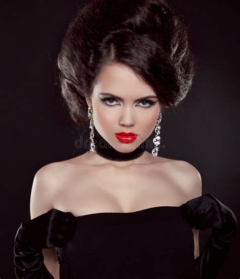 Portrait Of Beautiful Brunette Woman With Red Lips Over Dark Stock