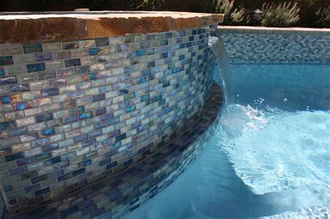 Iridescent Blue 1” X 2” Glass Tile Surrounds The Pool And Raised Spa On The Rai Modern